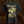 A black Brodequin band short-sleeve graphic t-shirt featuring the band name 'Brodequin' in a distressed gothic font above a sepia-toned illustration, displayed against a textured brown background.
