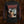 A black long-sleeve graphic t-shirt featuring the band name 'Inveracity' in a jagged red font across the chest, with a dark illustration of a woman with a knife held to her throat on the front, and repeated red Inveracity logos down one sleeve with an Unmatched Brutality Records logo down the other, displayed against a textured brown background.
