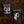 Black short-sleeve graphic Inveracity band t-shirt shown from both front and back. The front features the red spiky 'Inveracity' logo above a dark, surreal graphic.