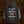 A black hoodie shown from the back, featuring a gothic-style white and red graphic print that reads 'everyone has gone to the divination' with occult-style symbols. The left sleeve has white gothic text reading 'Unmatched Brutality'.